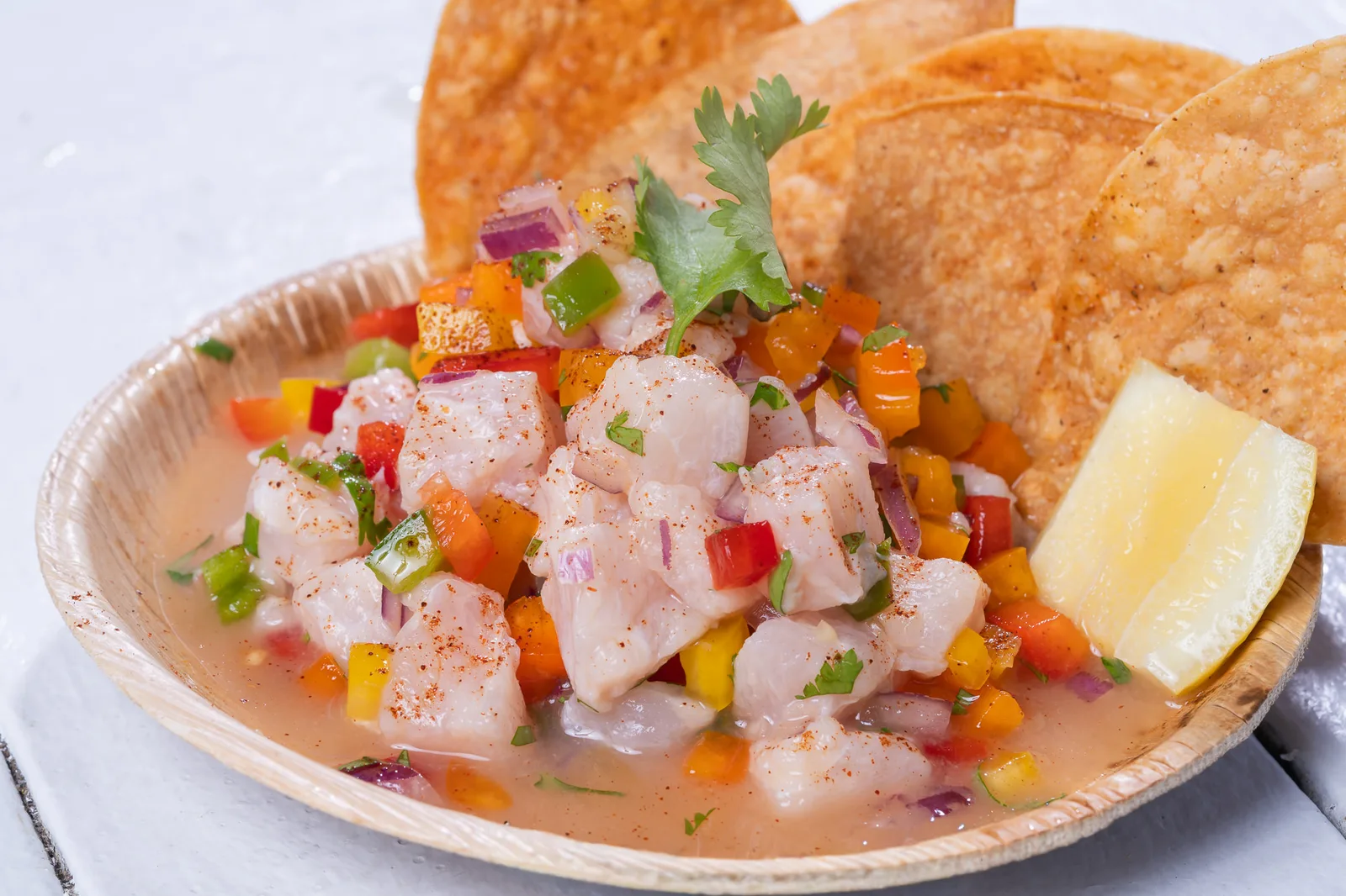 Fresh ceviche with colorful vegetables and crispy chips