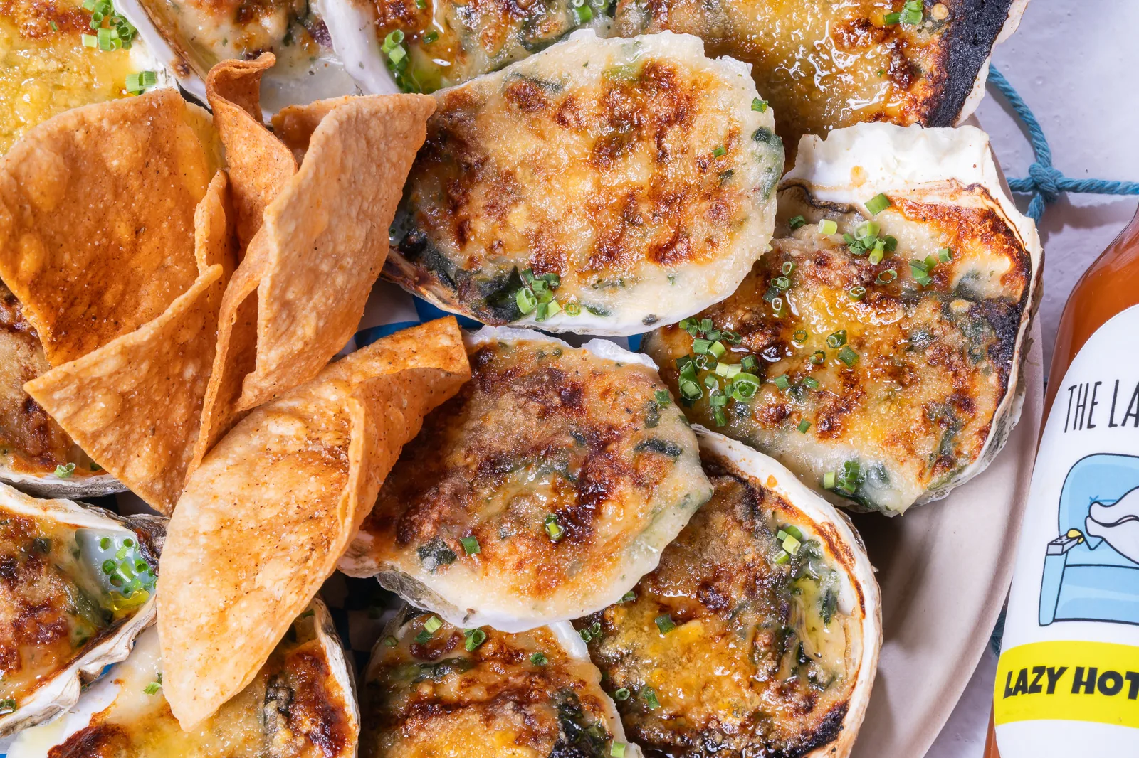 Chargrilled oysters with The Lazy Oyster hot sauce at a live catering event