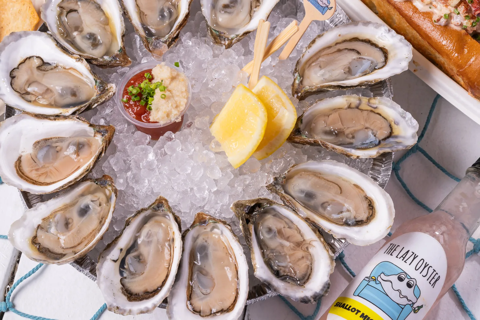 Fresh shucked oysters on ice with sauces and lemon