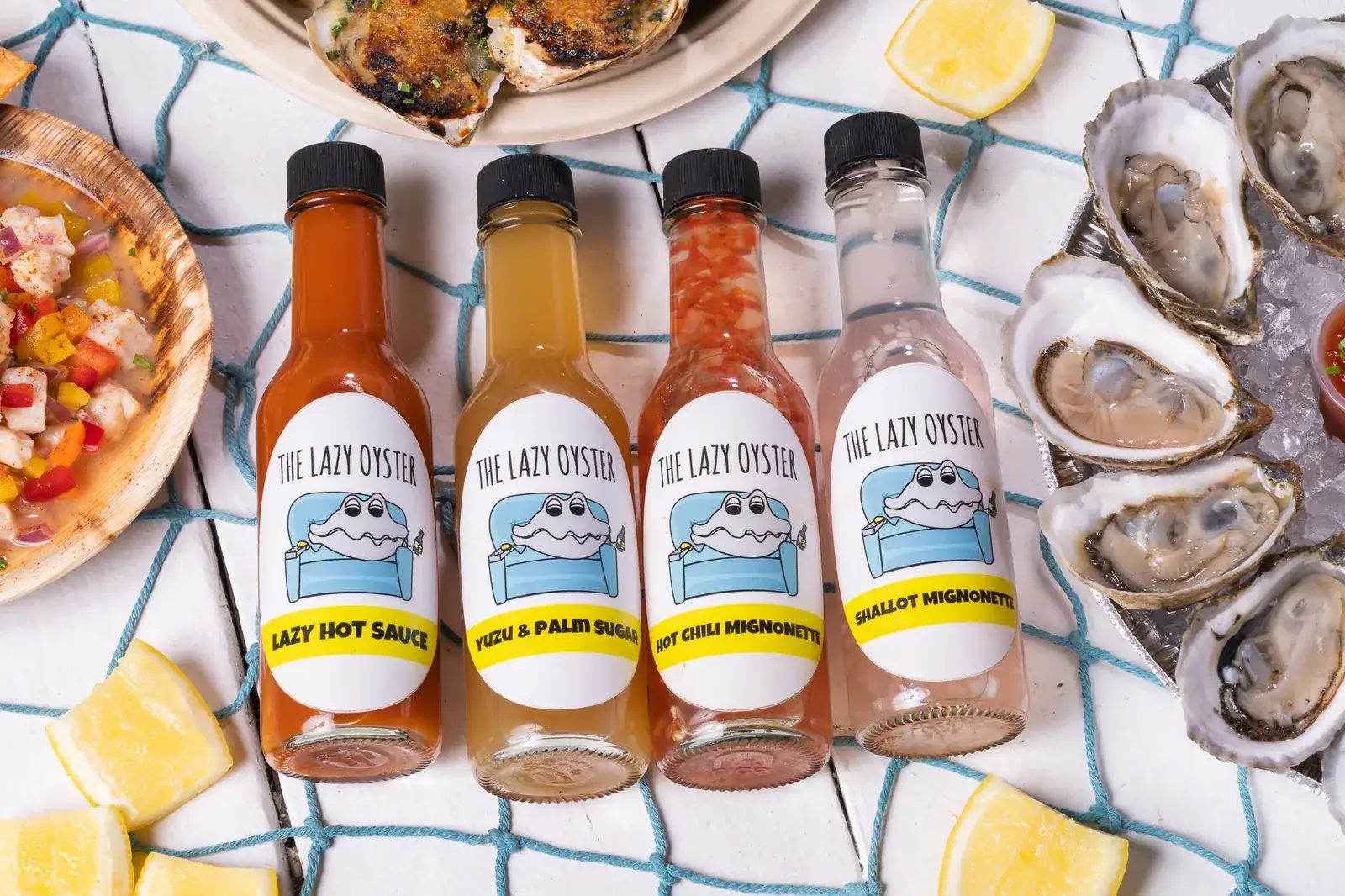 The Lazy Oyster signature sauce lineup: Lazy Hot Sauce, Yuzu Palm Sugar, Chili Mignonette, Shallot Mignonette