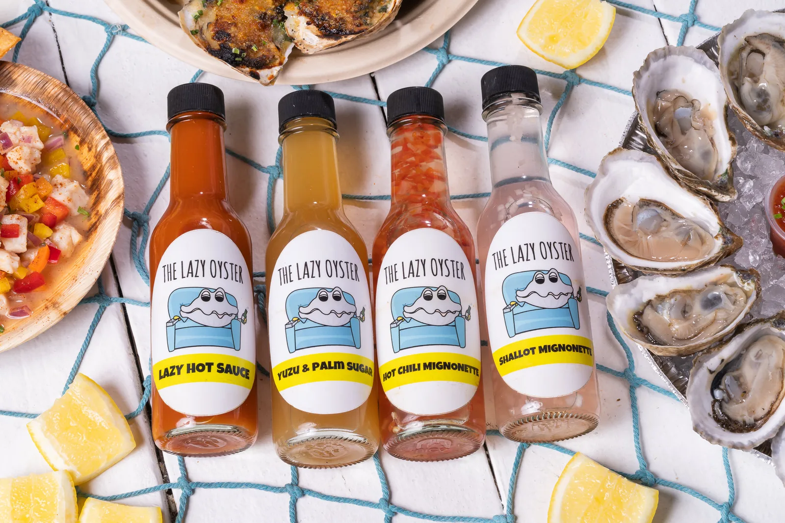 The Lazy Oyster signature sauce lineup: Lazy Hot Sauce, Yuzu Palm Sugar, Chili Mignonette, Shallot Mignonette